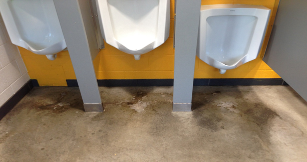 polished concrete floor in a men's washroom